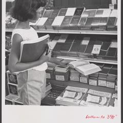 A young shopper selects school supplies