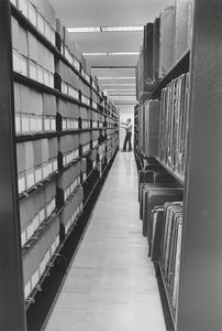 Researcher in the stacks in the west room of the UW-Parkside archives