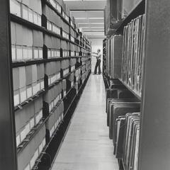 Researcher in the stacks in the west room of the UW-Parkside archives