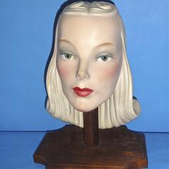 Ceramic head with long, tightly curled blond hair