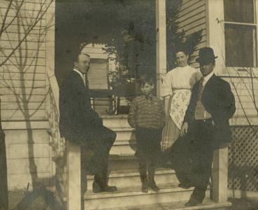 Unknown family on porch of unknown residence