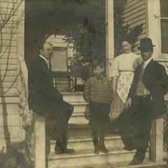 Unknown family on porch of unknown residence