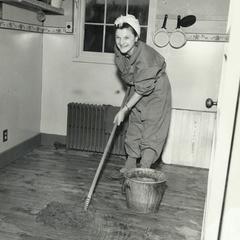 Woman mopping in dorm