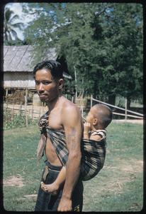 Lao man with tattoos (with child)