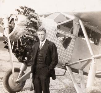 Lindbergh standing by his plane