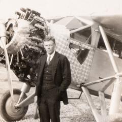 Lindbergh standing by his plane