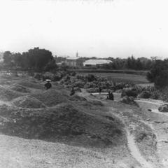 [Hilltop view of village and villagers]