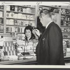 A saleswoman assists a customer at the tobacco counter