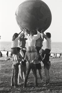 Students playing with an Earth Ball near shore of Green Bay