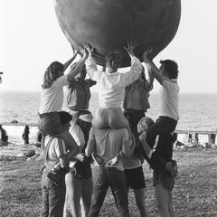 Students playing with an Earth Ball near shore of Green Bay