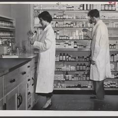 Two pharmacists prepare prescriptions