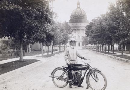 Oneida Co. agent E.L. Luther with motorcycle