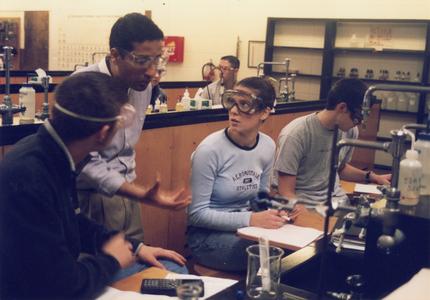 Chemistry professor Mohamed Ayoub with students in lab