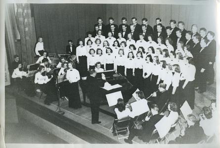 Stout Symphonic Singers, Orchestra, and Band members performing a concert