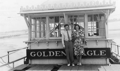 Photograph of two passengers in front of the pilothouse of the Golden Eagle