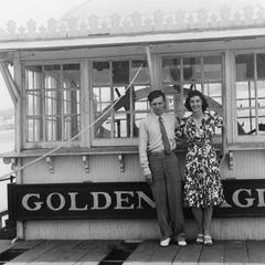 Photograph of two passengers in front of the pilothouse of the Golden Eagle