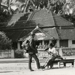 A soldier stands and talks with his wife in the city of Luang Prabang in Luang Prabang Province