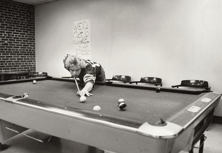 Student playing pool, Janesville, 1980