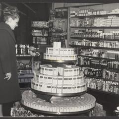 A woman views a display of vitamins at a drugstore