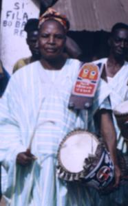 Man standing with drum during Iwude procession