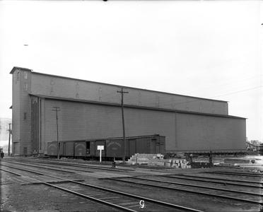 Elevator 'G' with Northern Pacific Railcars and Worker