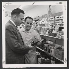 Pharmacy employee helps man select item
