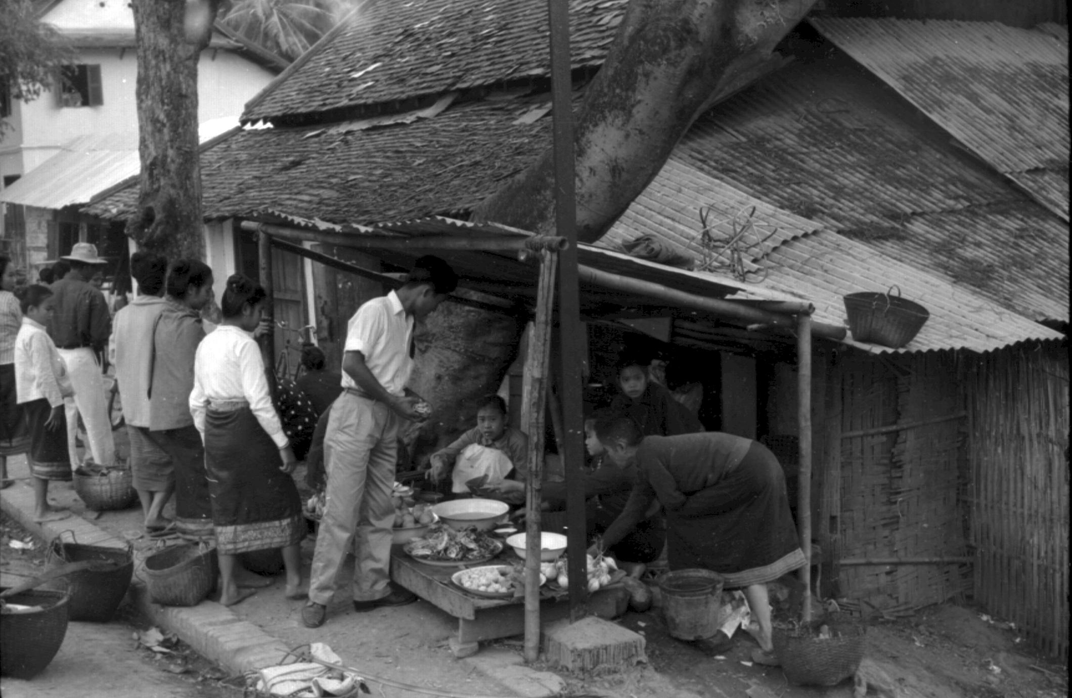 Lao women selling prepared food in shed