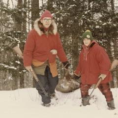 Dr. Cook and son dragging buck