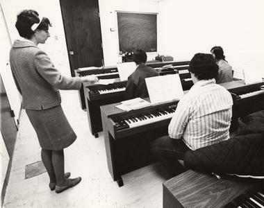 Music professor Anna Asche teaching students piano
