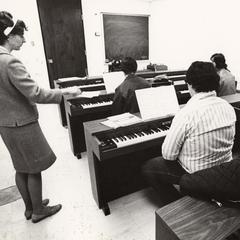 Music professor Anna Asche teaching students piano