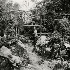 Jean Habert, photographer and French volunteer, enters the territory of a Yao village in the vicinity of Muang Vang Vieng in Vientiane province