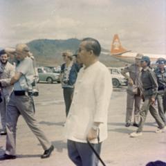 Prince Souvanna Phouma walks to greet Prince Souphanouvong at the airport in Luang Prabang