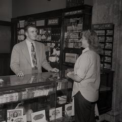 Co-ed making a purchase at information desk