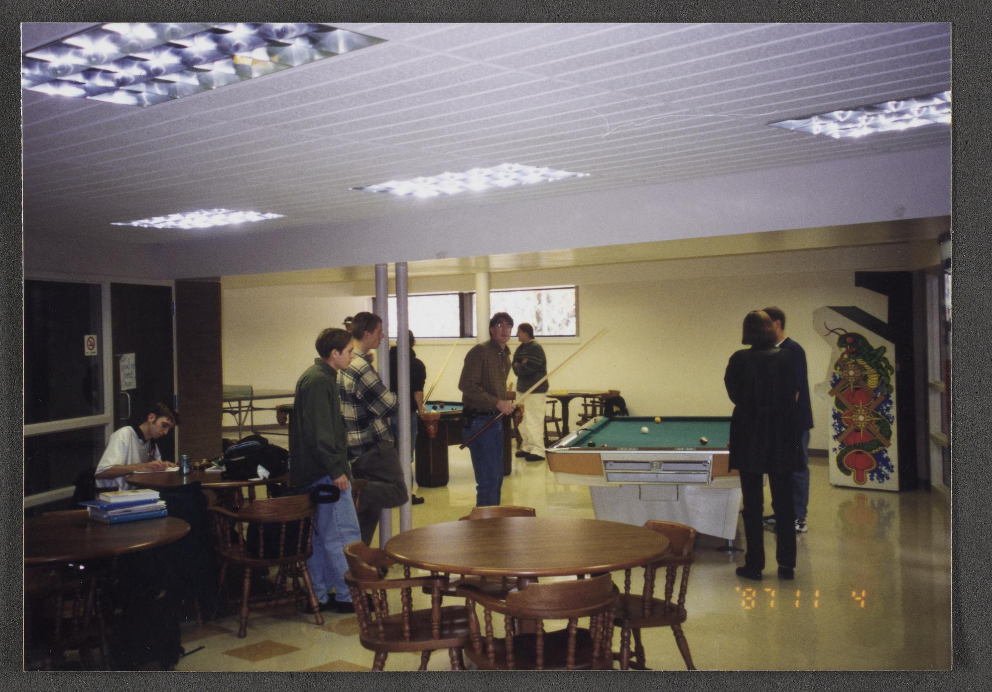Students playing pool, studying and interacting in the student union