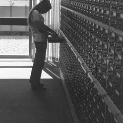 Student using the library card catalog