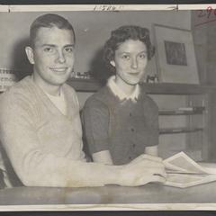 Young woman and man pose at a table