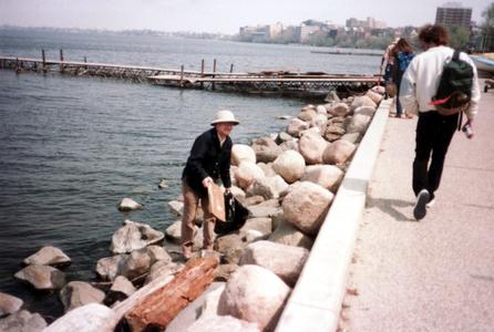 John Magnuson cleaning up along the shore of Lake Mendota