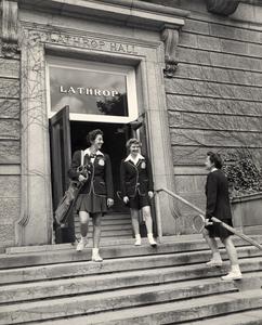 Women With Golf Clubs and Tennis Rackets Outside Lathrop Hall