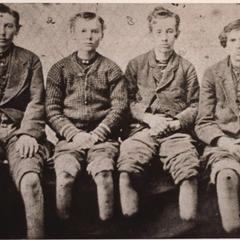 Photograph of four boys with amputated feet.