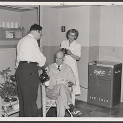 Pharmacy staff serve coffee to a waiting physician