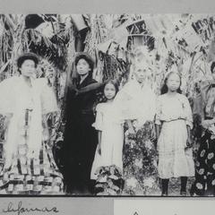 Filipino women and girls standing among some banana trees