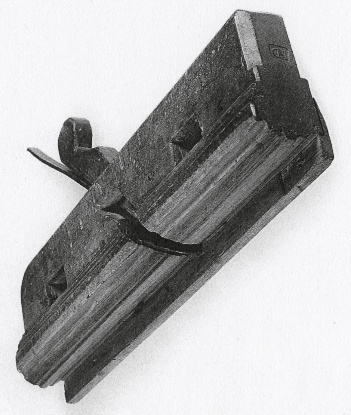 Black and white photograph of a molding plane.