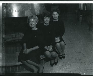 Alpha Phi members sitting by fireplace