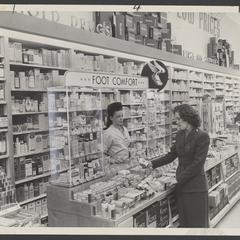 Woman looks at products at the foot comfort section of a pharmacy