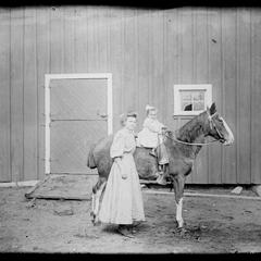 Woman with child on horse