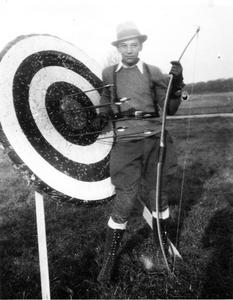 Carl Leopold next to bow and arrow target