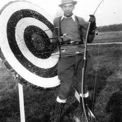 Carl Leopold next to bow and arrow target