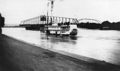 Sternwheel view of the Capella by a Mississippi River bridge
