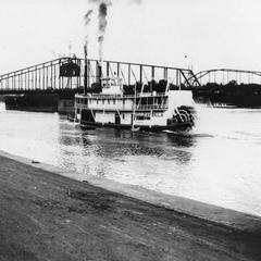 Sternwheel view of the Capella by a Mississippi River bridge