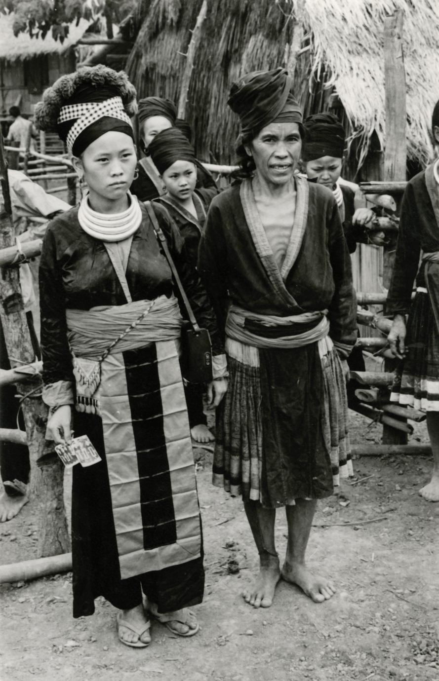 Two Hmong women stand in a Hmong village in the vicinity of Muang Vang Vieng in Vientiane Province